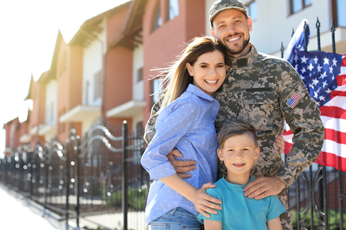 American soldier with family outdoors. 