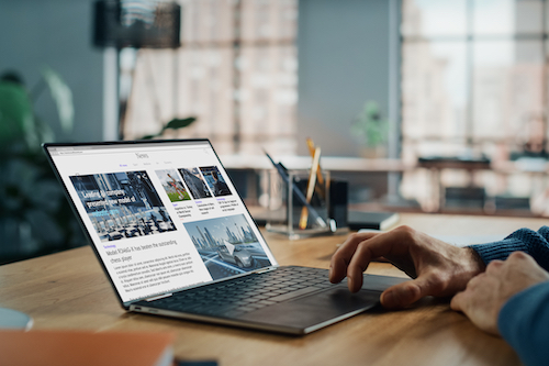 man-reading-recent-news-on-laptop