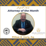 August 2026 Attorney of the Month graphic featuring William M. Gearty, Esq. His portrait is centered within a gold circle. The Suffolk County Bar Association logo appears on the left and the Legal Services of Long Island logo appears on the right.