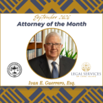 September 2026 Attorney of the Month graphic featuring Ivan E. Guerrero, Esq. His portrait is centered within a gold circle. The Suffolk County Bar Association logo appears on the left and the Legal Services of Long Island logo appears on the right.